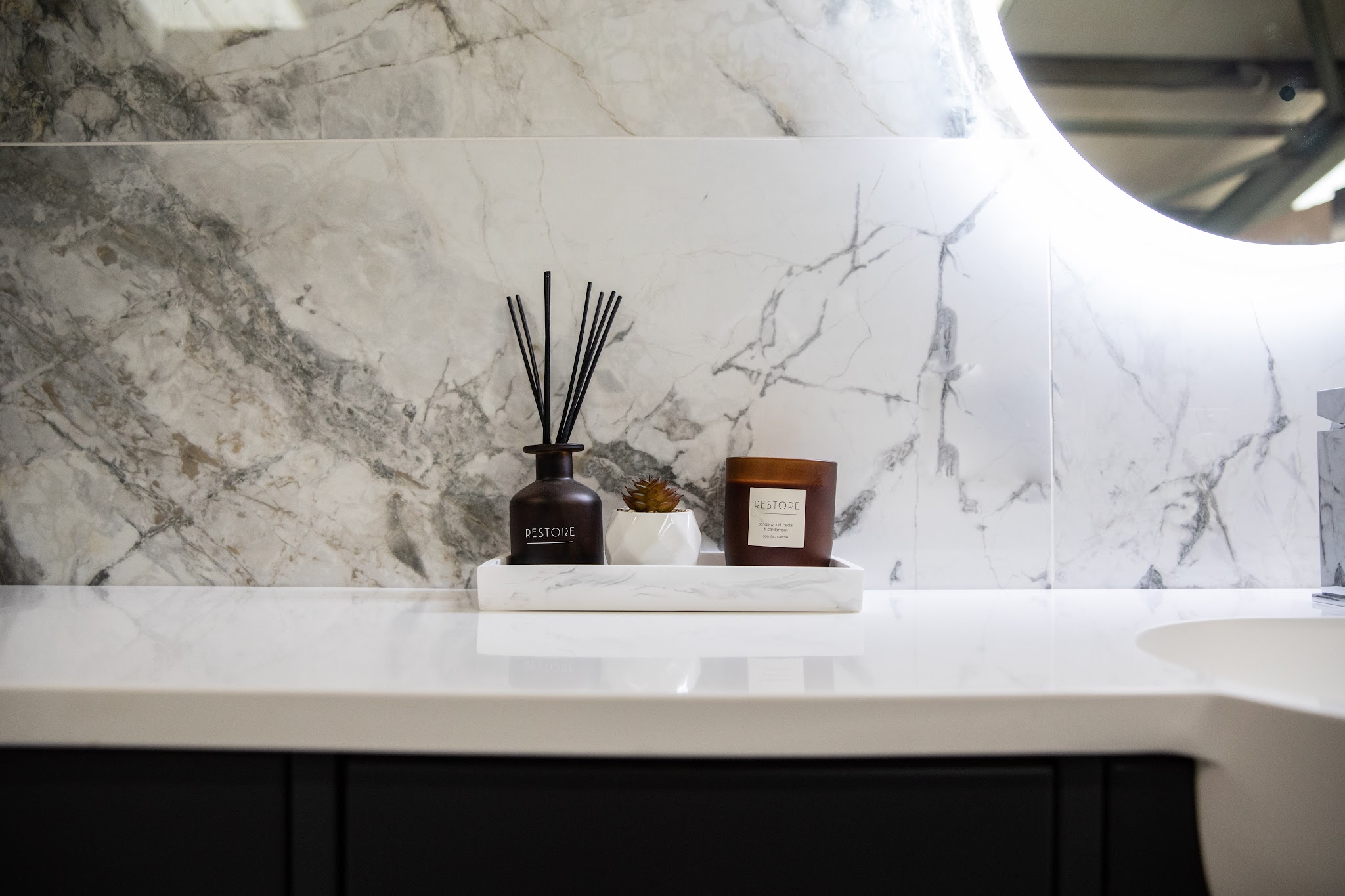 Marble-effect vanity top with a reed diffuser