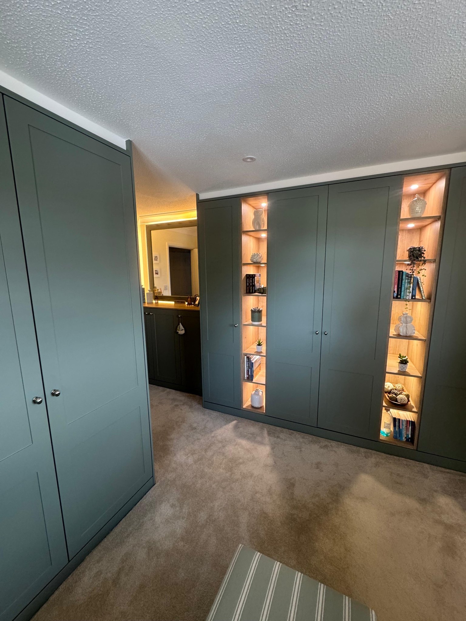 Reed green fitted wardrobes with lit display shelving